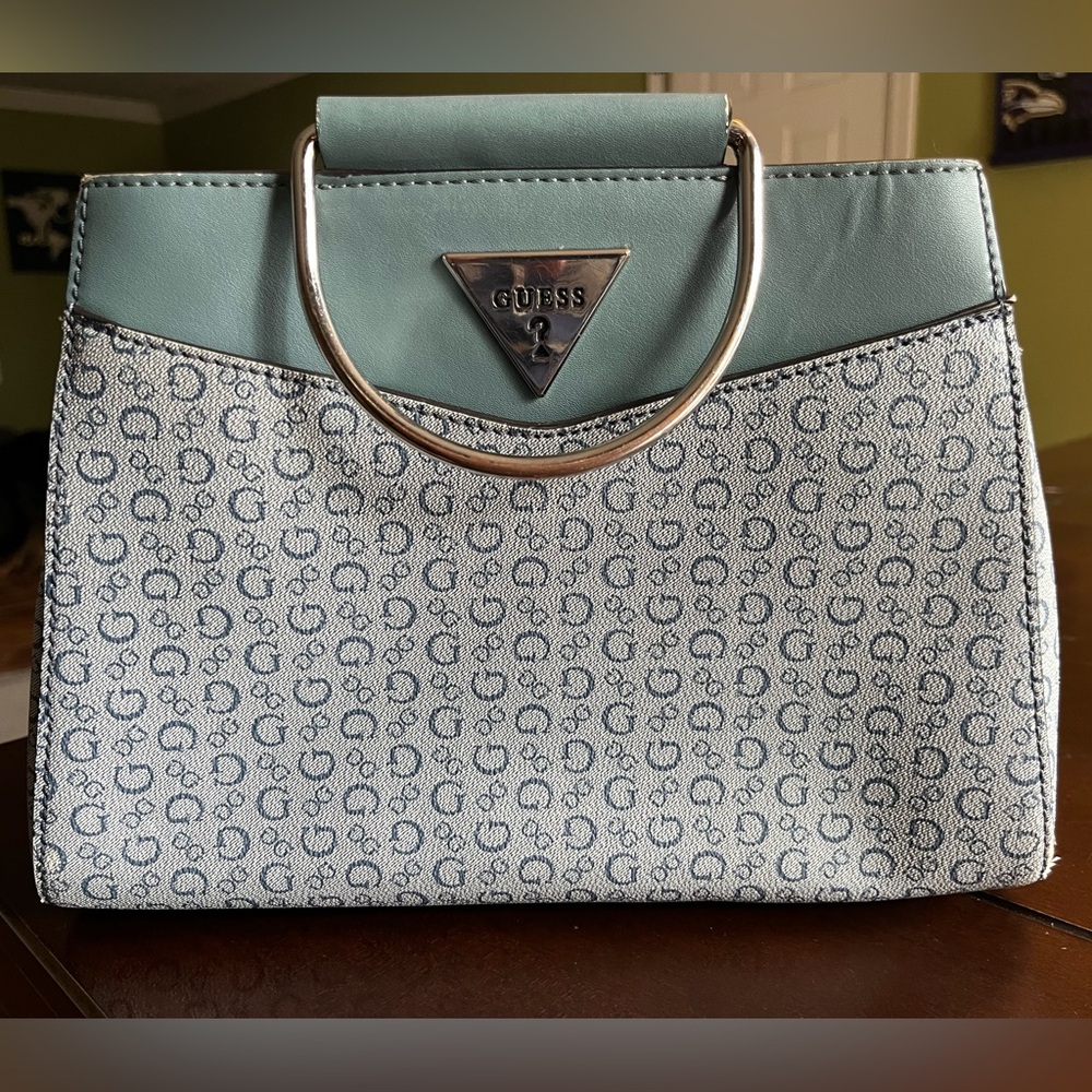 Grey/bluish grey Guess handbag with metal rings.